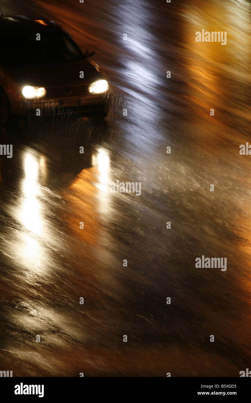 fast car driving in heavy rain at night in town Stock Photo - Alamy