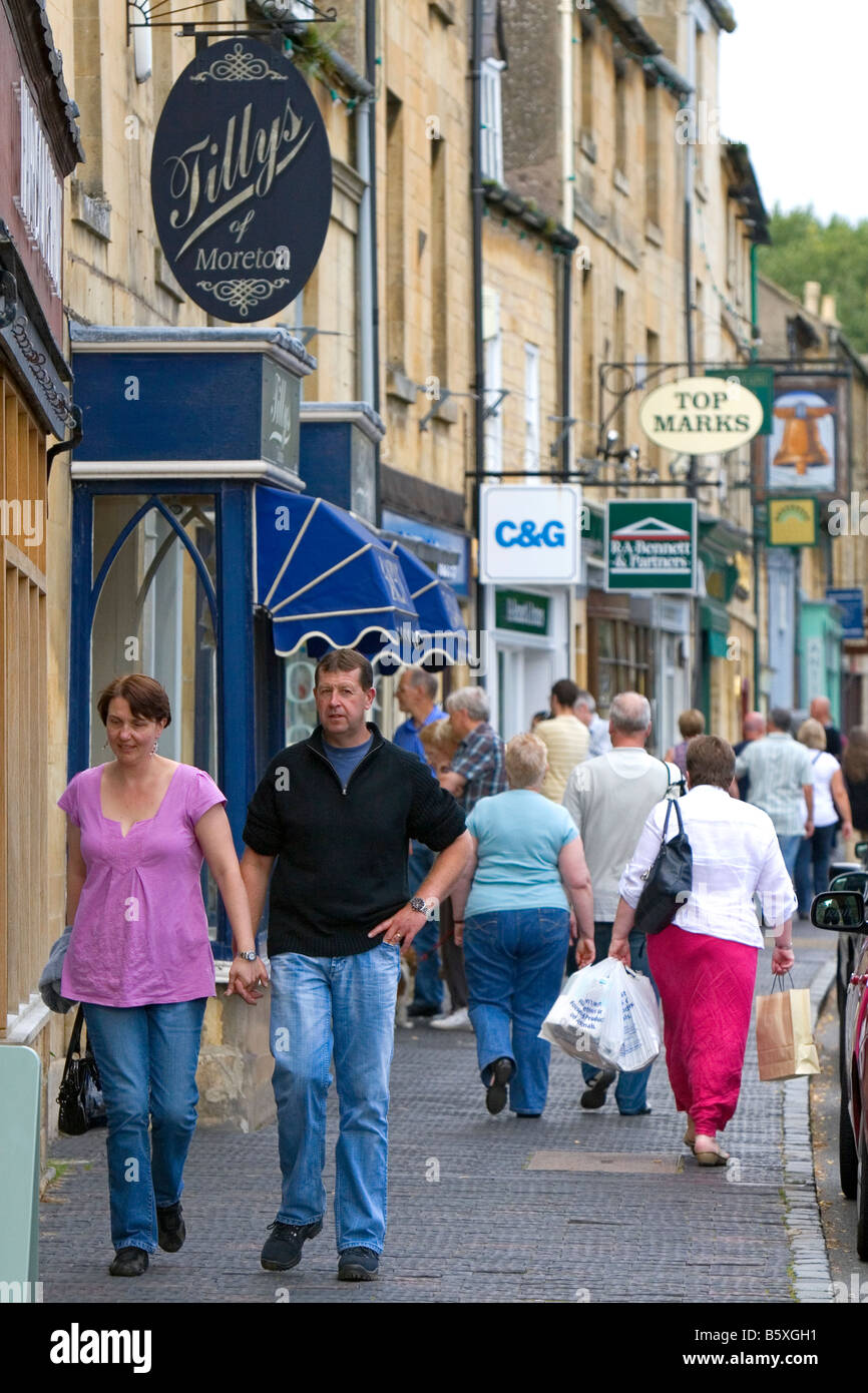 People walk and shop in the town of Moreton in Marsh Gloucestershire