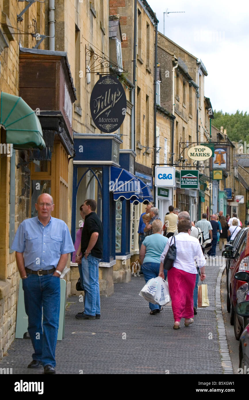 People walk and shop in the town of Moreton in Marsh Gloucestershire