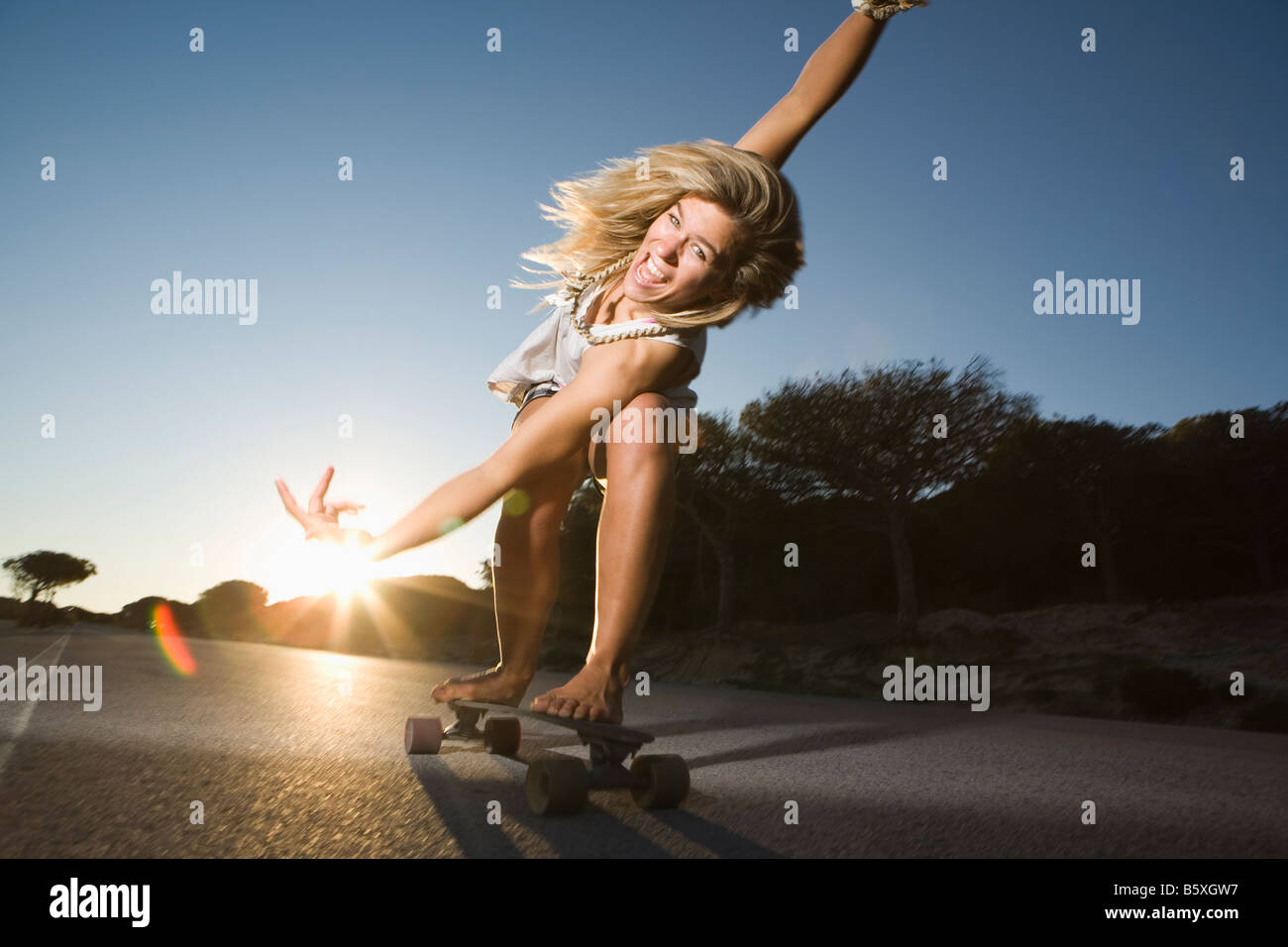 Woman on skateboard with crazy facial expression Stock Photo