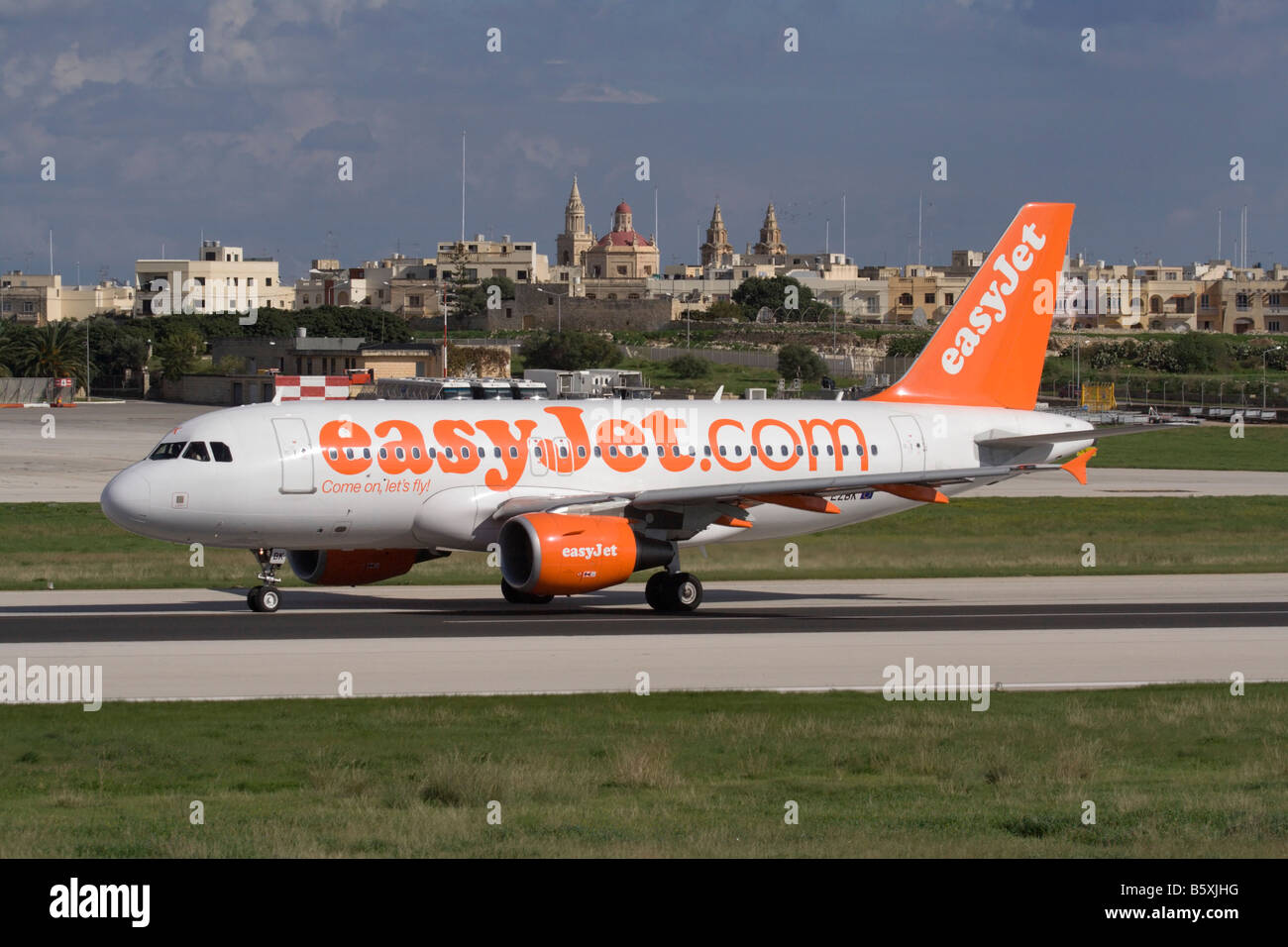 Low cost air travel. Airbus A319 jet plane belonging to budget airline easyJet shown departing from Malta Stock Photo