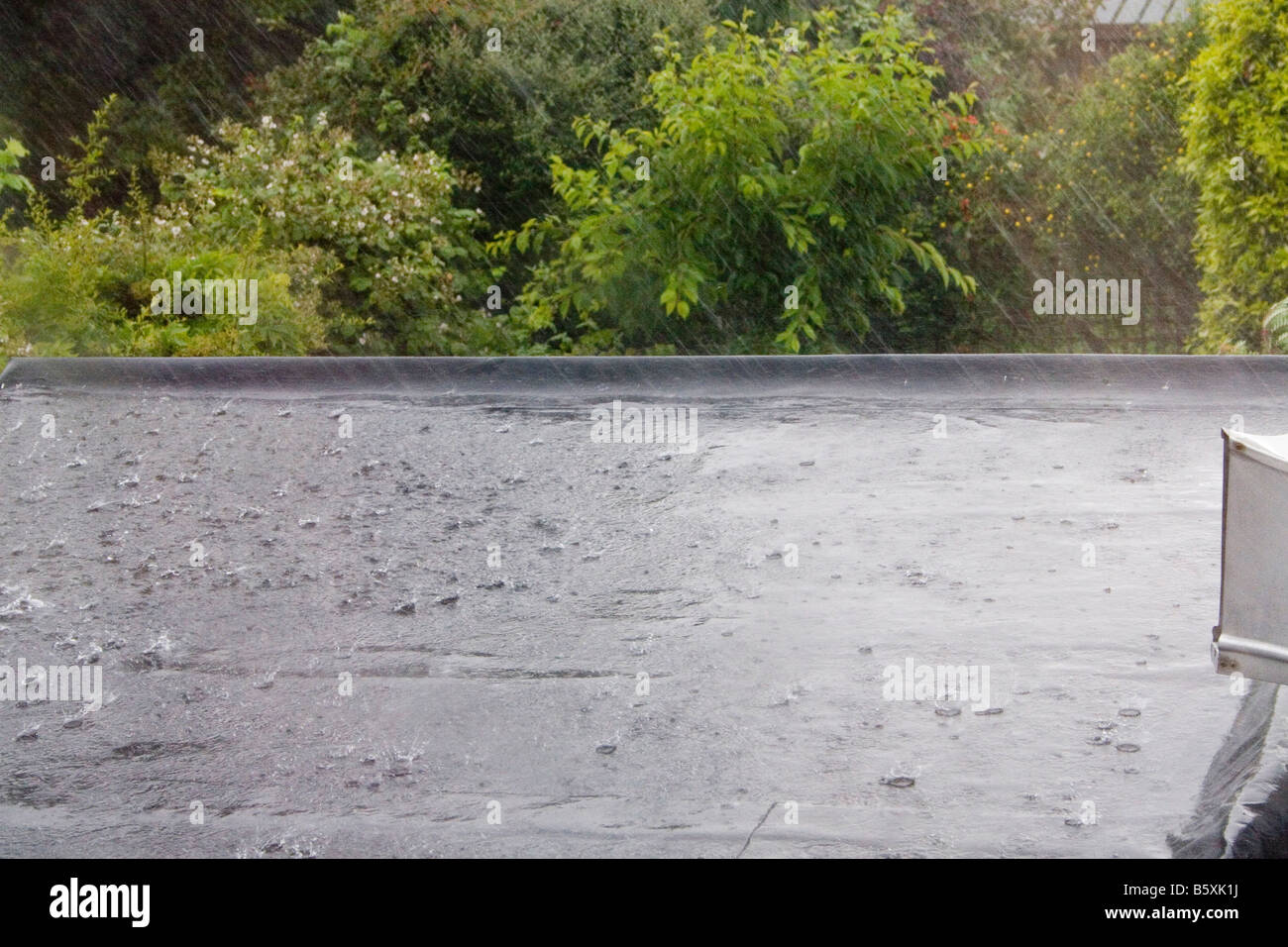 Heavy rain in the summertine on flat roof of a house in Ireland Stock Photo