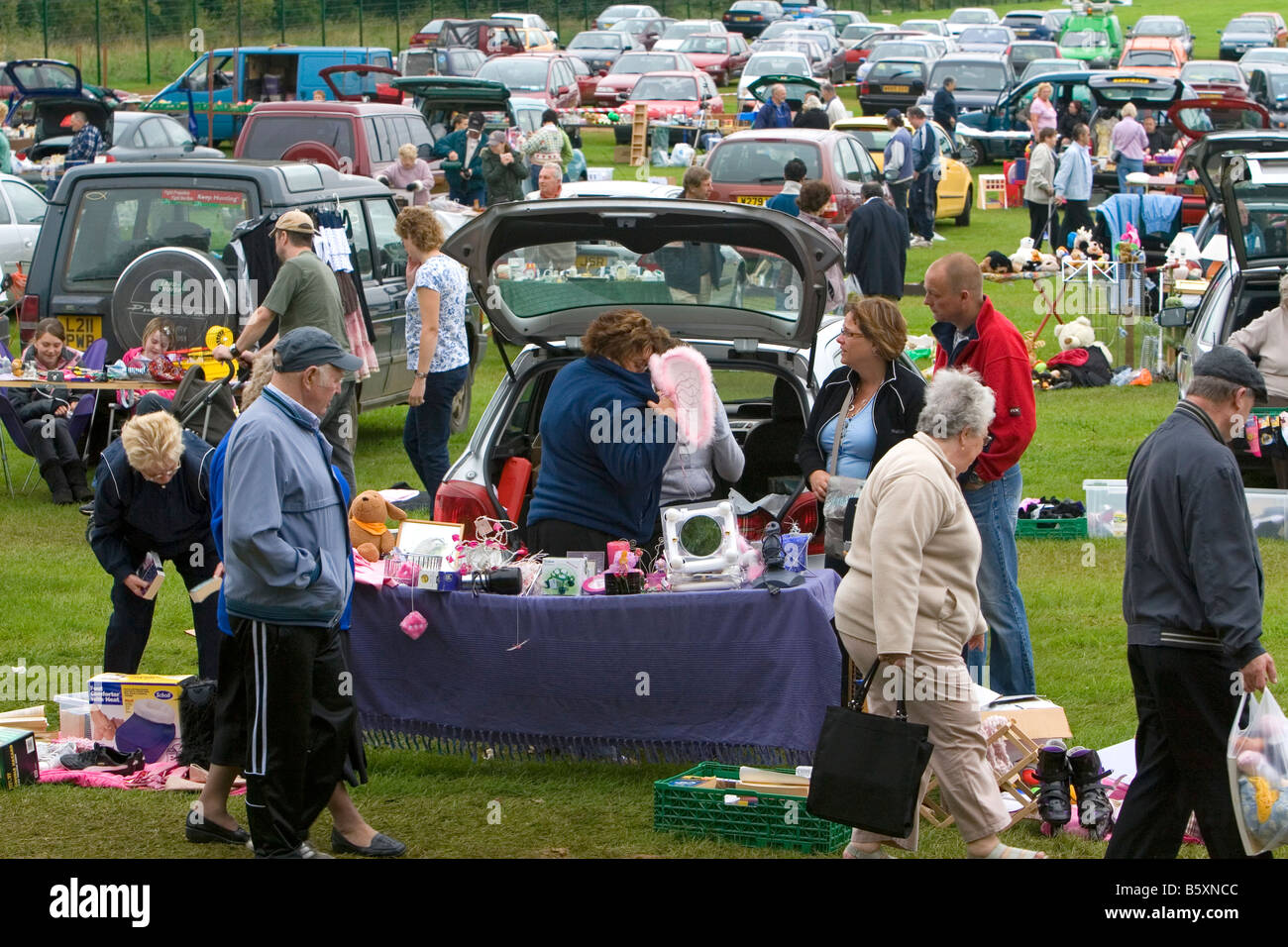 People buy and sell household items at a car boot sale in the market town of Banbury Oxfordshire England Stock Photo