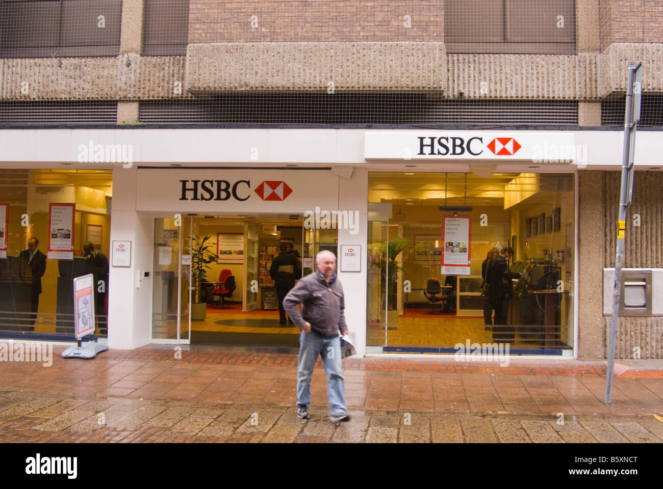 Entrance to HSBC bank with people coming out in the city centre of Norwich,Norfolk,Uk Stock Photo