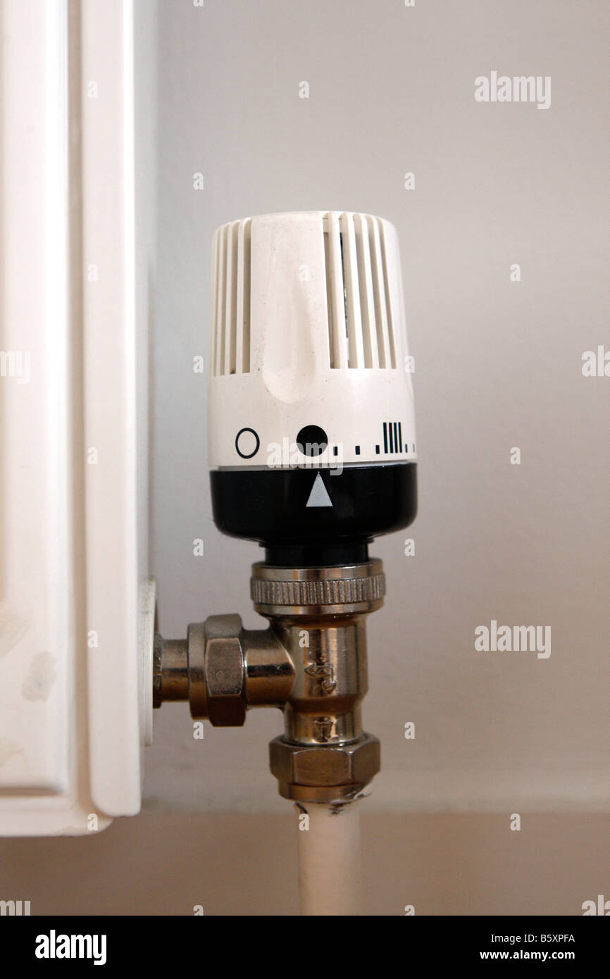 A manual thermostat control on a central heating radiator Stock Photo