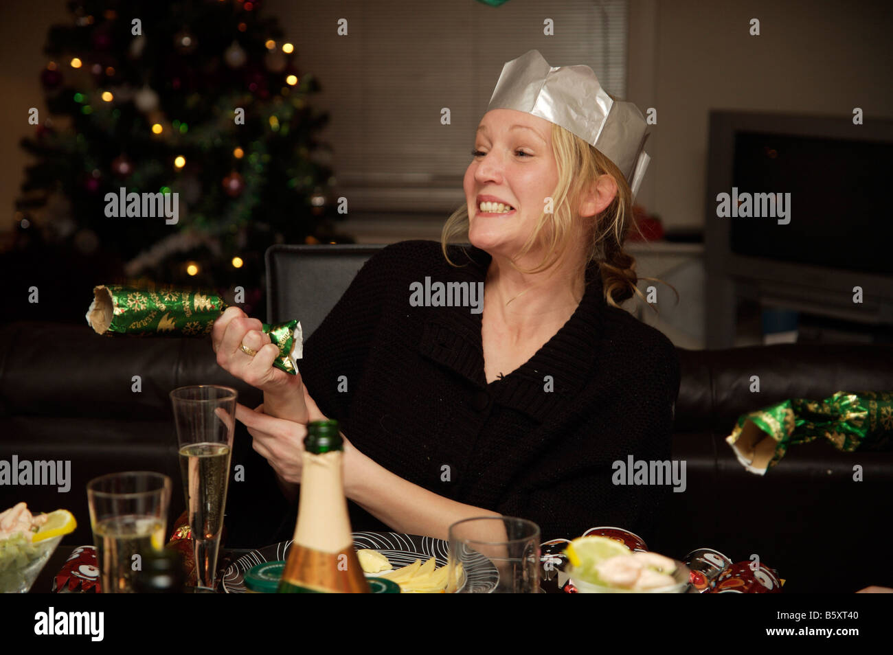 Woman aged 29 pulling a cracker on christmas day Stock Photo Alamy