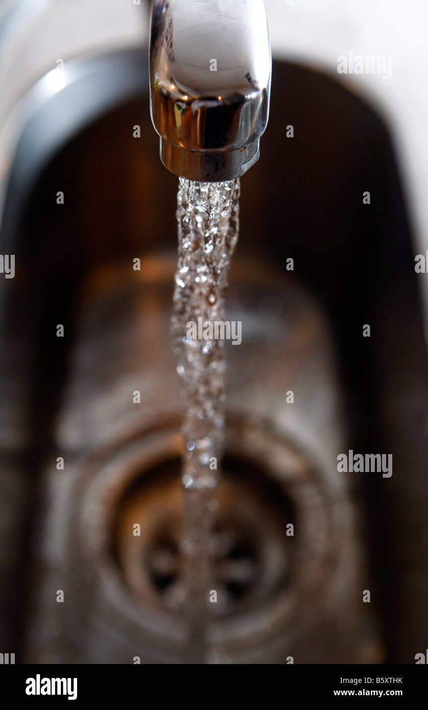 Water gushing from a domestic tap fawcet Stock Photo