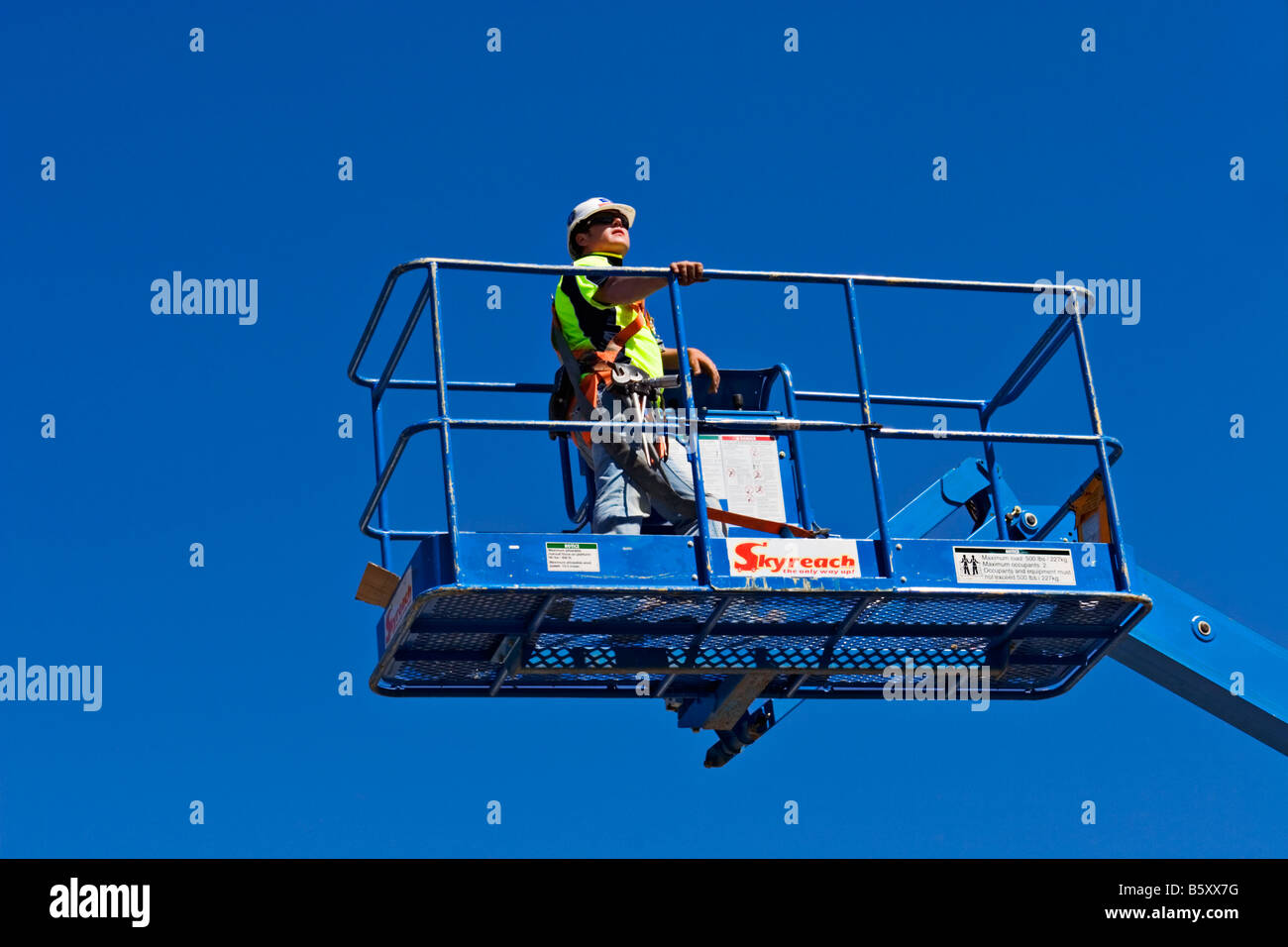 Construction / A Construction worker, works safely from a Hydraulic Boom Lift.Melbourne Victoria Australia. Stock Photo