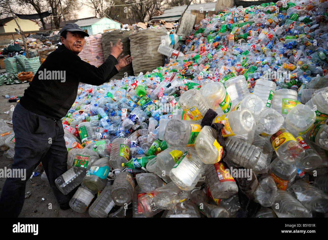 Chinese man collects plastics bottles at a recycling station in outskirts of Beijing, China. 20-Nov-2008 Stock Photo