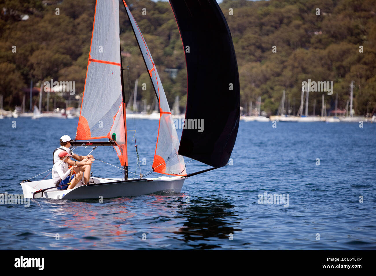 two sailors on the water in their dinghy sailing boat Stock Photo