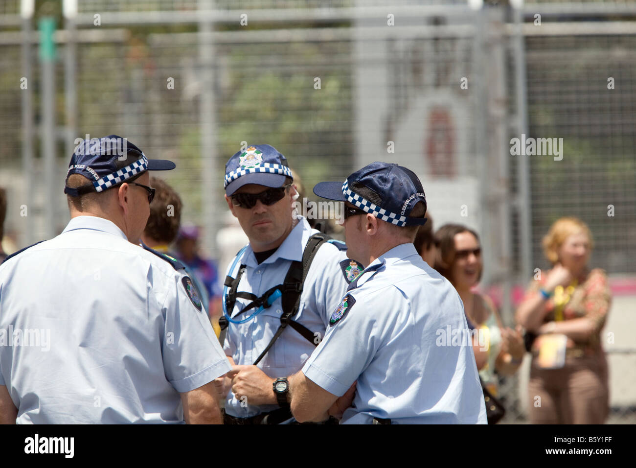 three australian queensland policemen in discussion at 2008 INDY 300 motor racing event,surfers paradise,gold coast,Australia Stock Photo