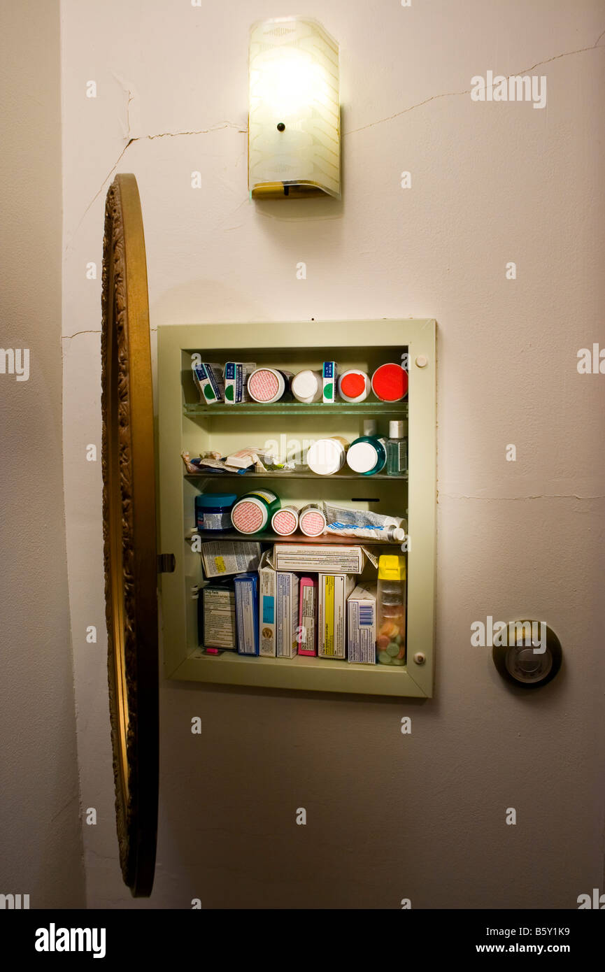 A medicine cabinet is open showing both prescription and over the counter (OTC) drugs. Stock Photo
