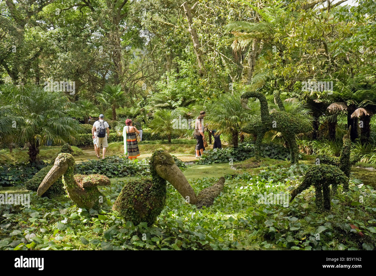 Artificial birds and tourists in the Jurassic Park part of the Terra Nostra park in Furnas, Azores, Portugal Stock Photo