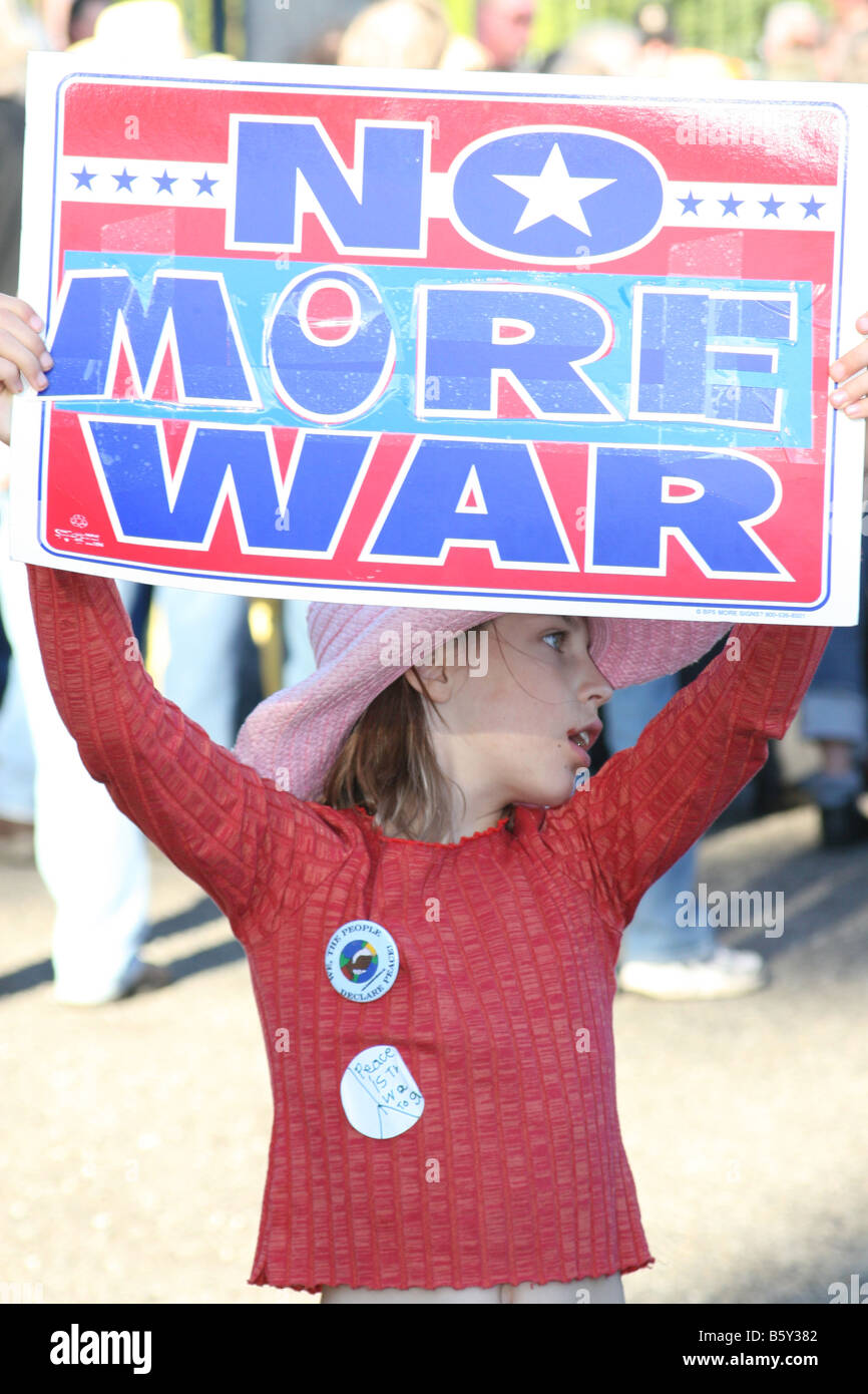 Young girl holds up a sign protesting war. Stock Photo
