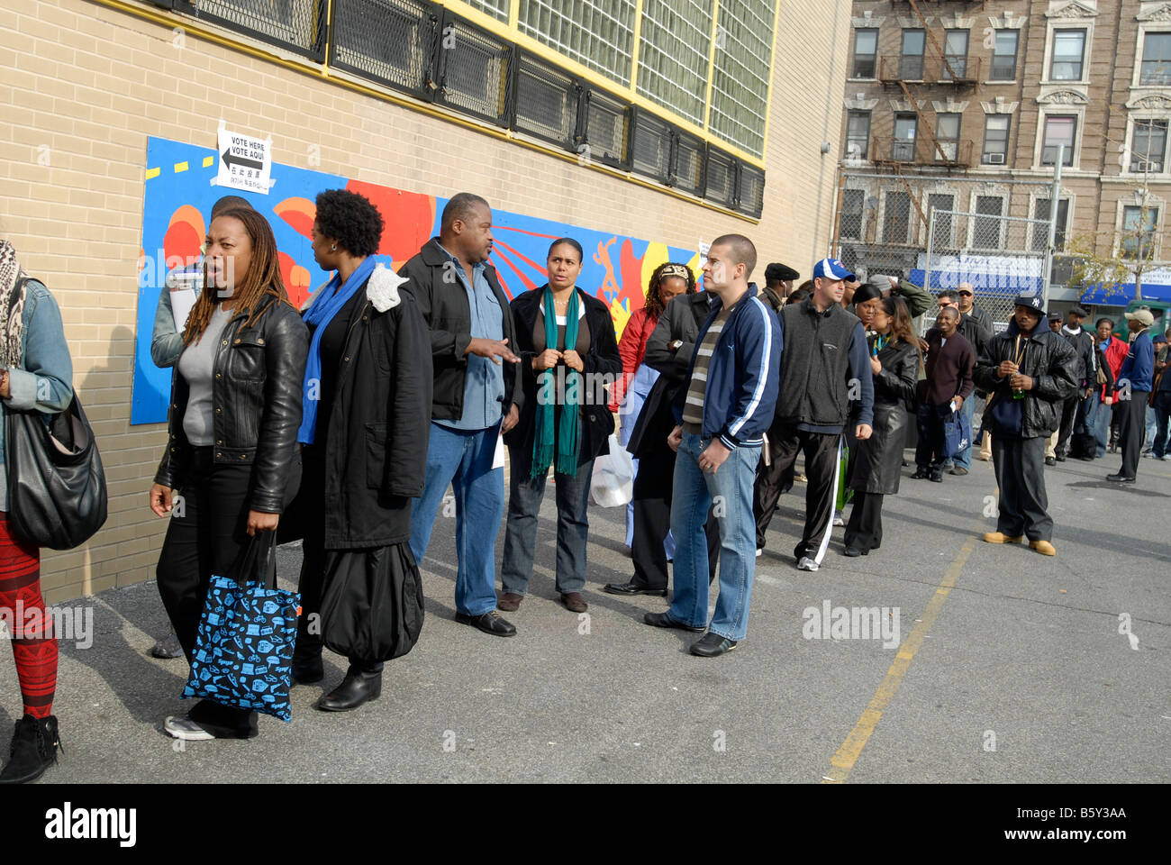 Voters wait on line to vote in the Harlem neighborhood of New York on