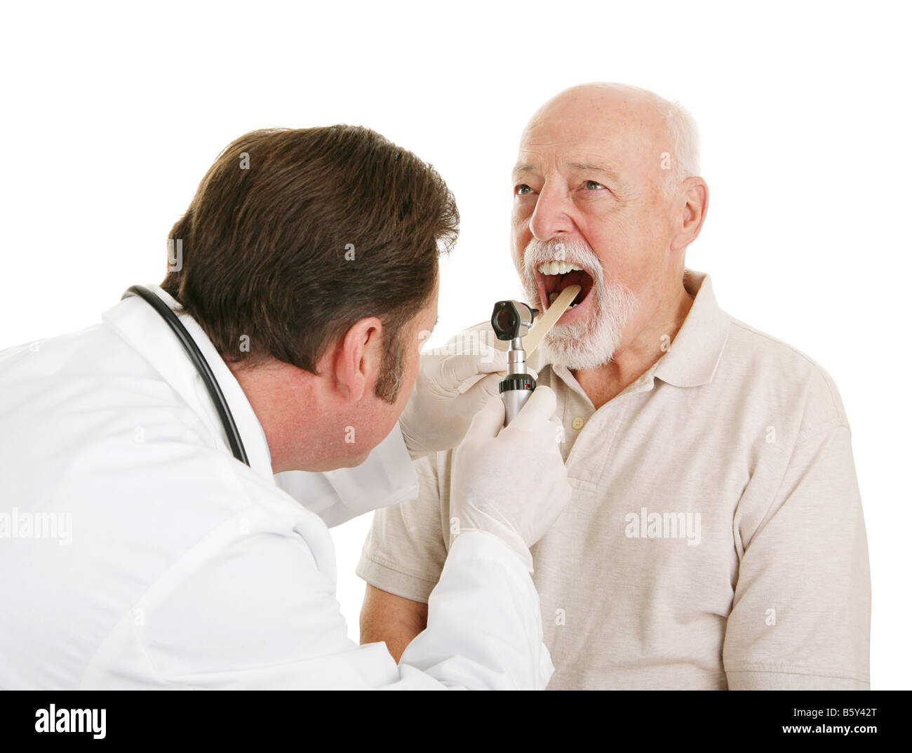 Doctor using a tongue depressor and an otoscope to look inside a senior
