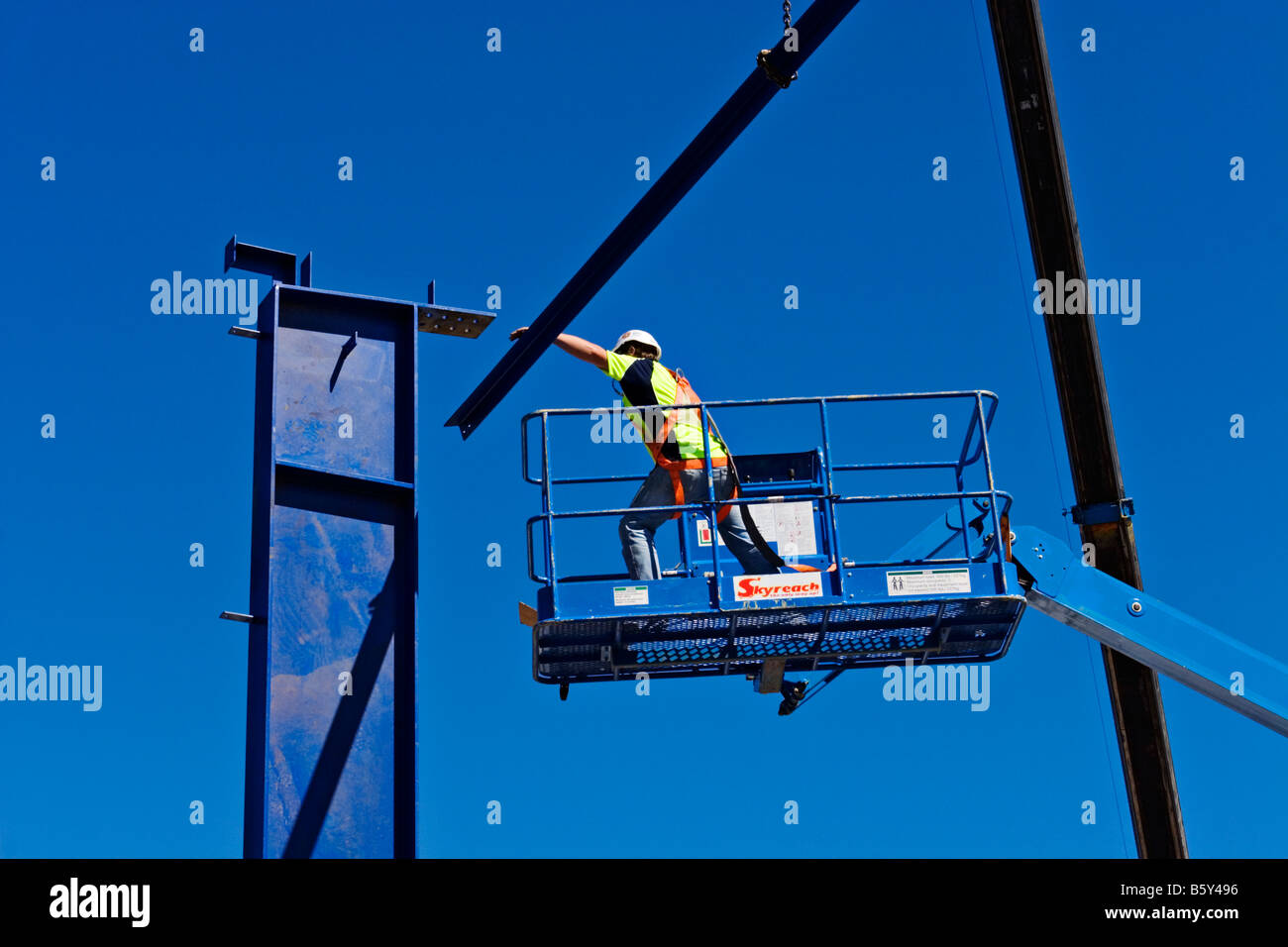 Construction / A Construction worker, works safely from a Hydraulic Boom Lift.Melbourne Victoria Australia. Stock Photo