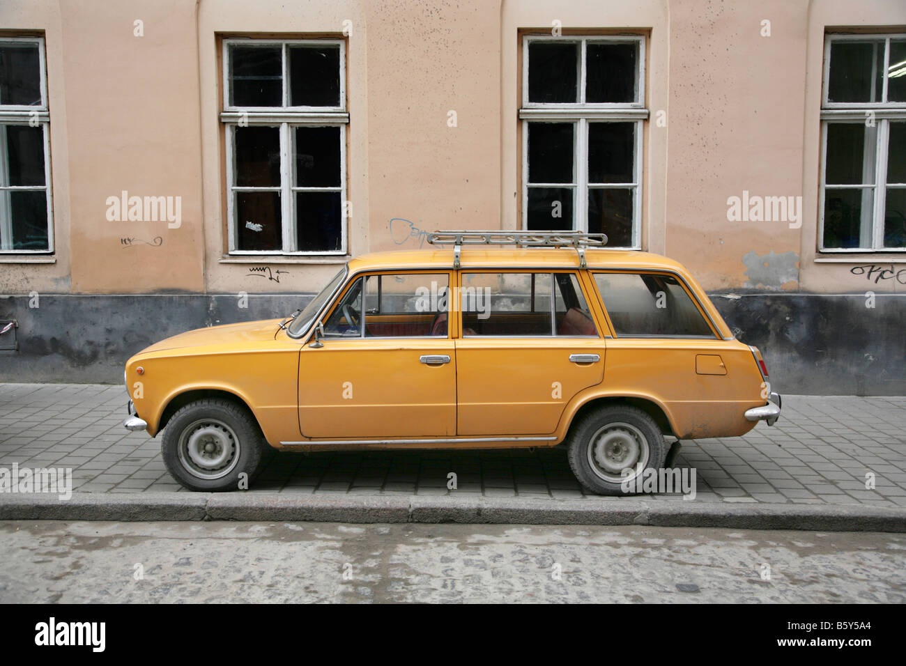 Old dirty orange Lada estate car in the Ukraine. Stock Photo