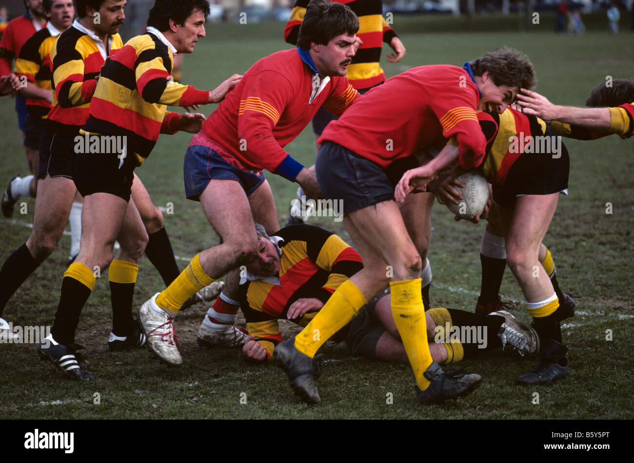 Rugby game with players going after ball carrier tackling him Greenlake
