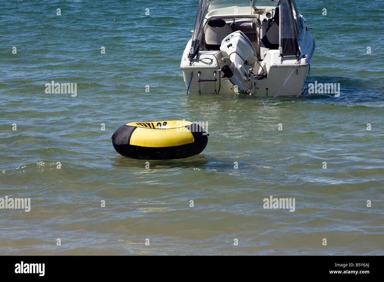 fun rubber ring trailing behind a motor boat Stock Photo Alamy