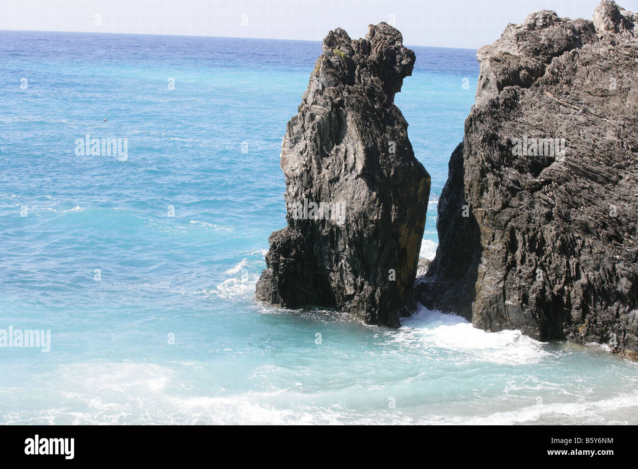 waves against rocks in Italy Stock Photo - Alamy