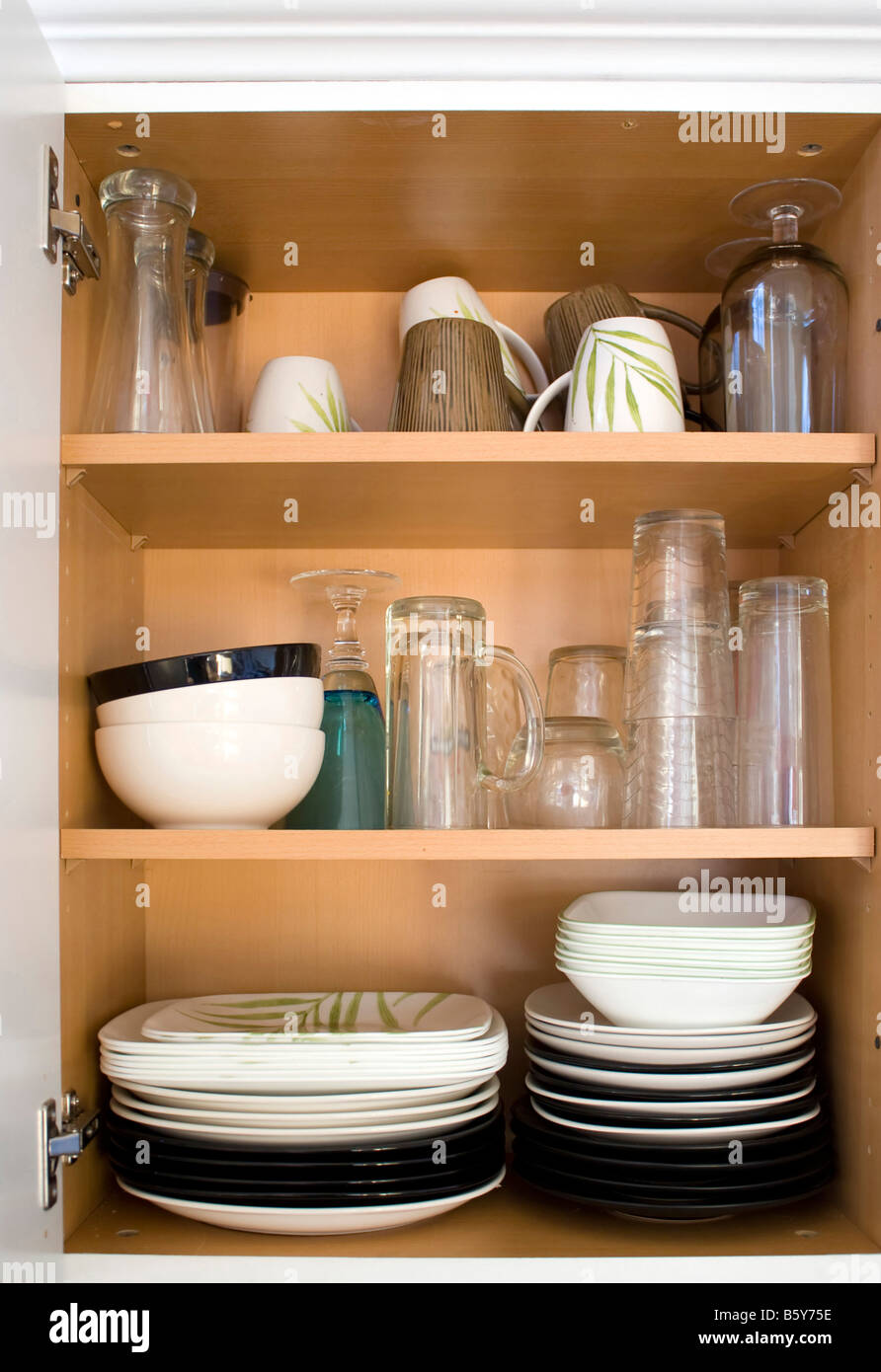 A full cabinet full of dishes and plates Stock Photo