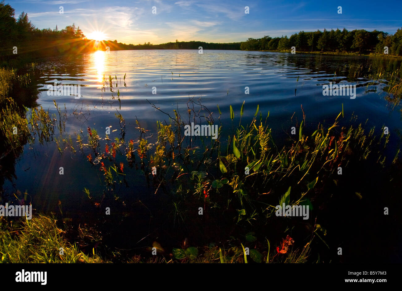 Sunset over Twin Pond in Old Forge in the Adirondack Mountains of New York State Stock Photo