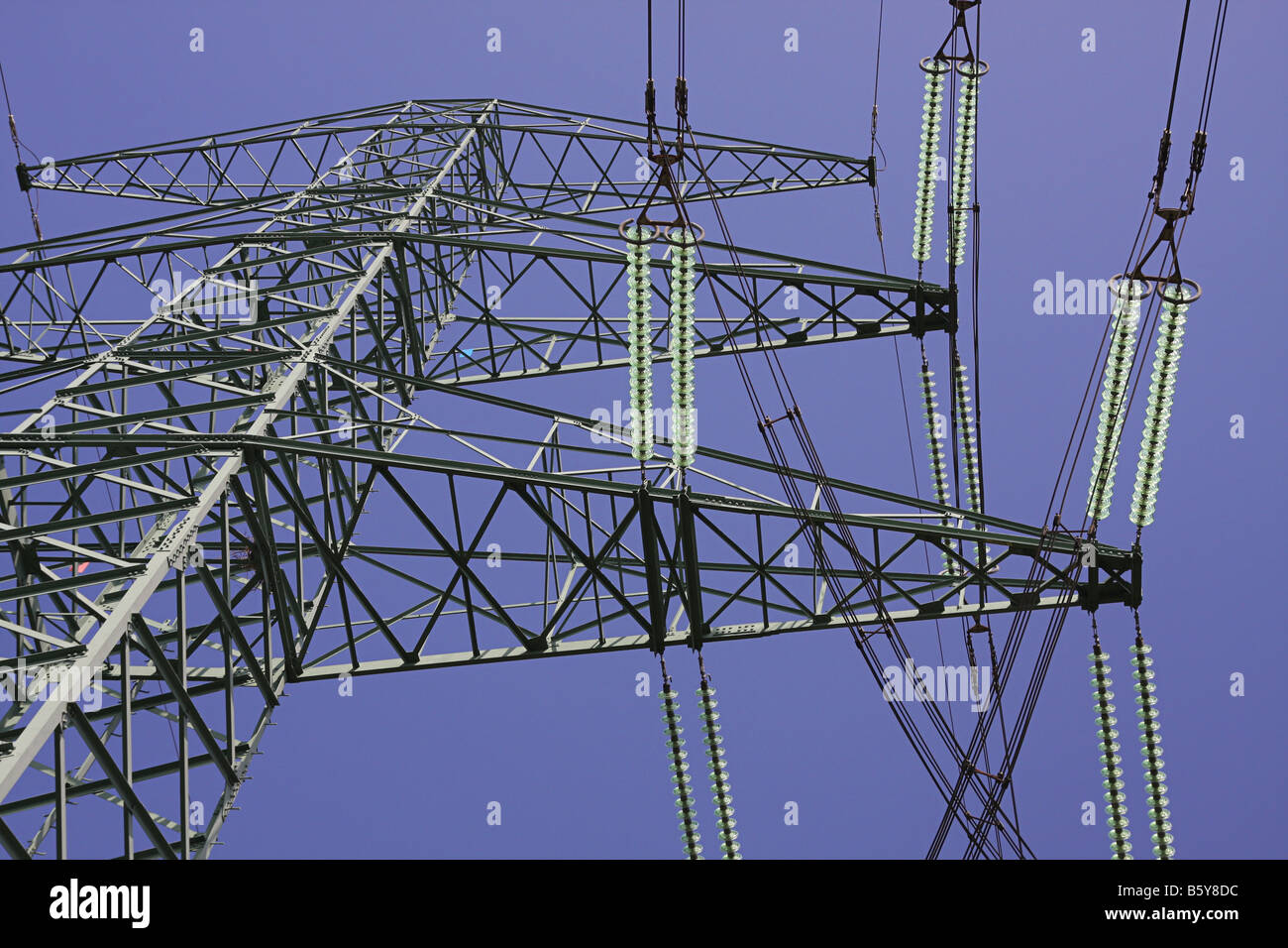 Electricity pylon against blue sky Stock Photo - Alamy