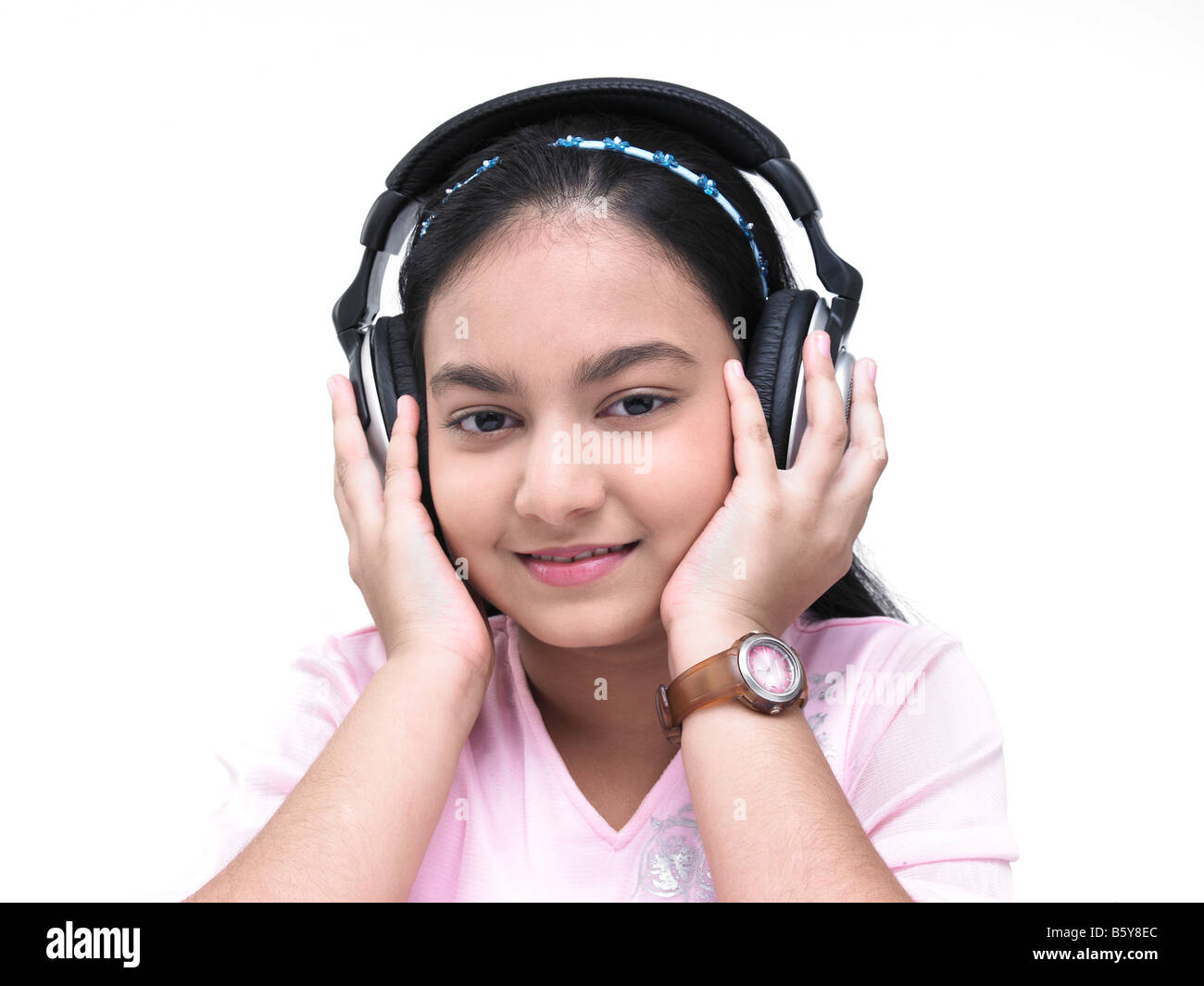 portrait of an asian teenage girl of indian origin listening to music Stock Photo