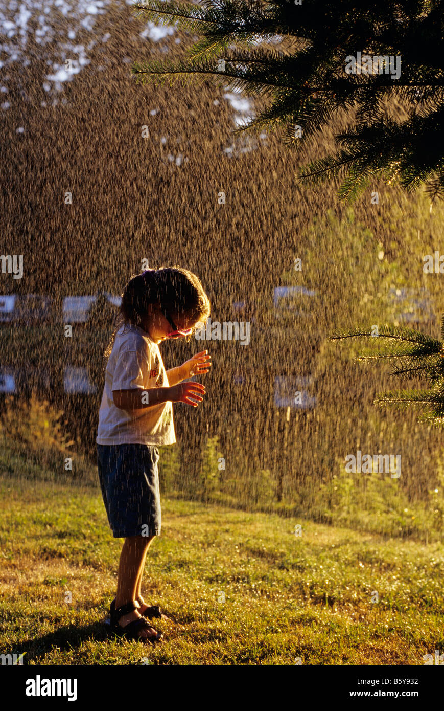 Young girl 4 playing in water spray during the summer at park Bothell ...