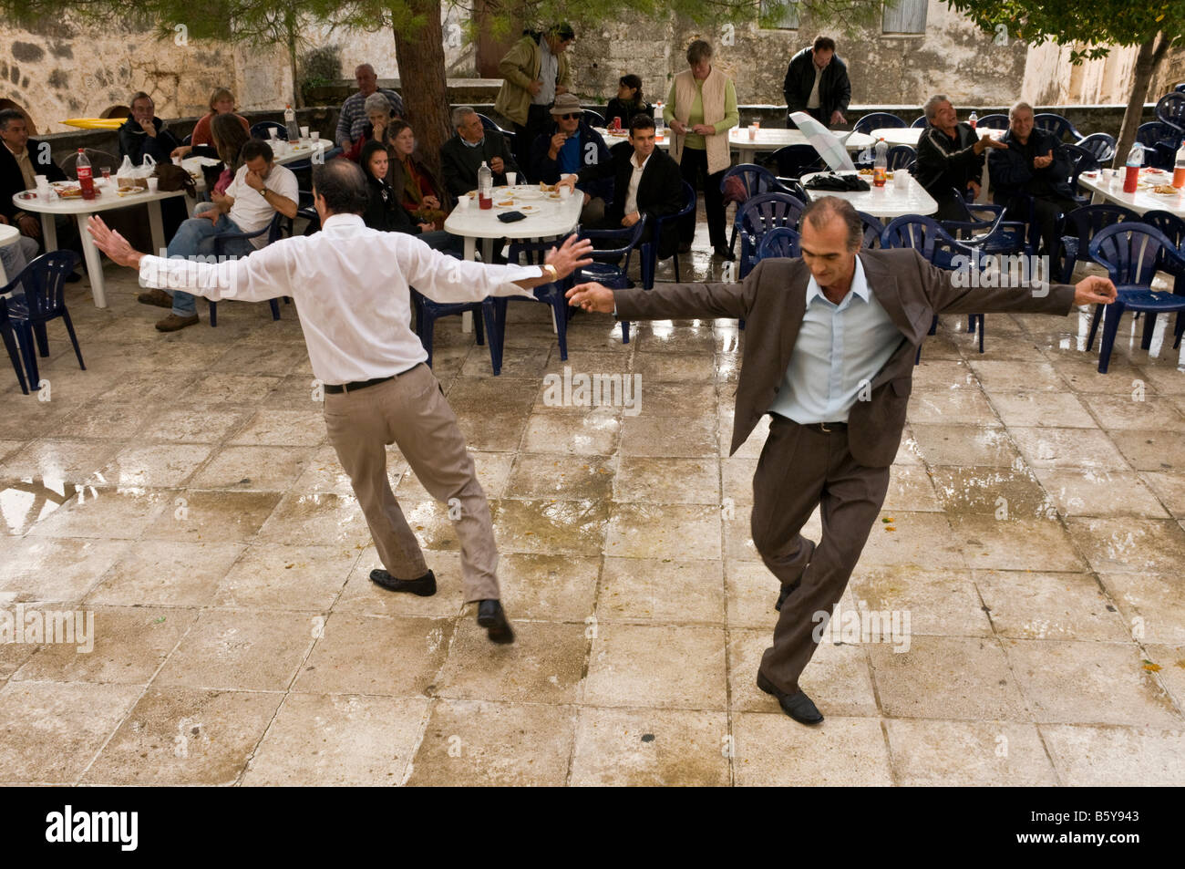 Greek men dancing at a Panayiri, a local festival. Proastio near Kardamili in the outer Mani Southern Peloponnese Greece Stock Photo