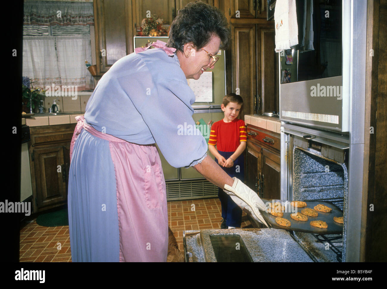 Grandmother bakes cookies for grandson Stock Photo