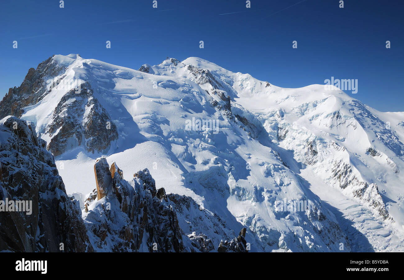 Steep white peaks and snow slopes in sunlight against blue deep sky the Alps Mont Blanc France Stock Photo
