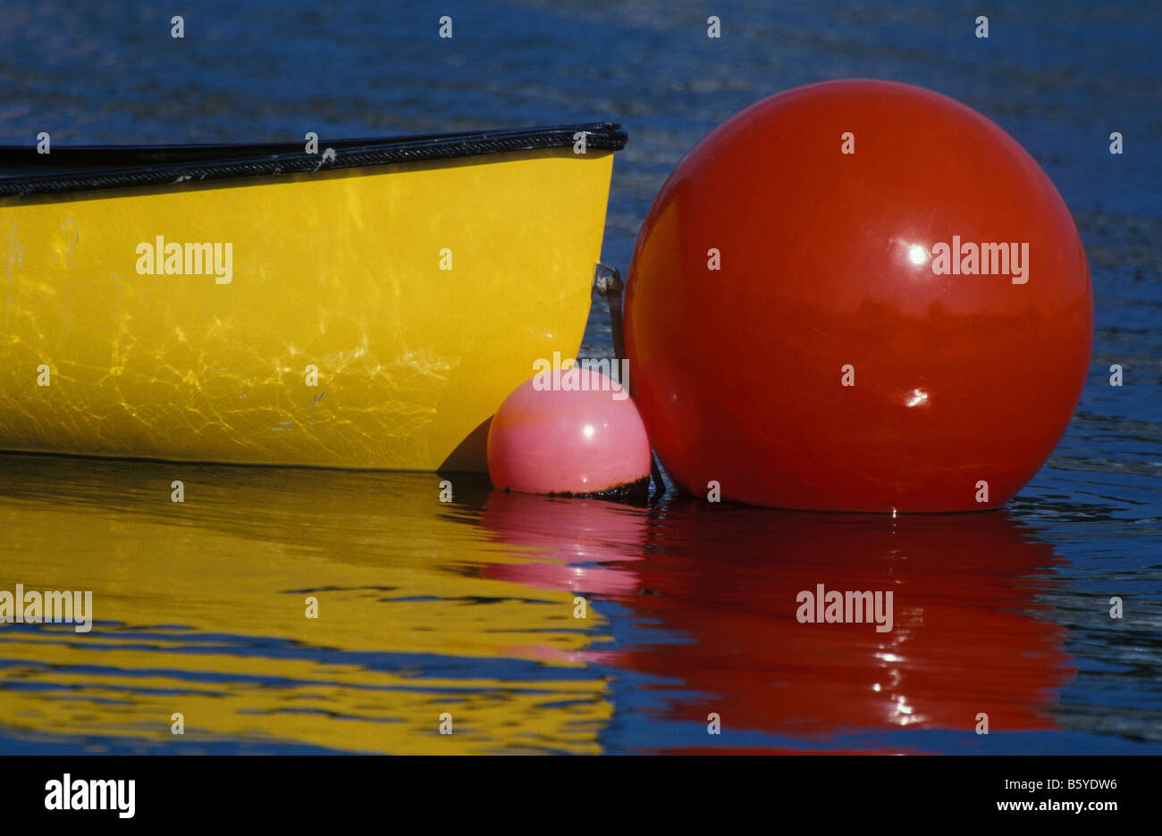 Boat anchored with flotation balloons Stock Photo