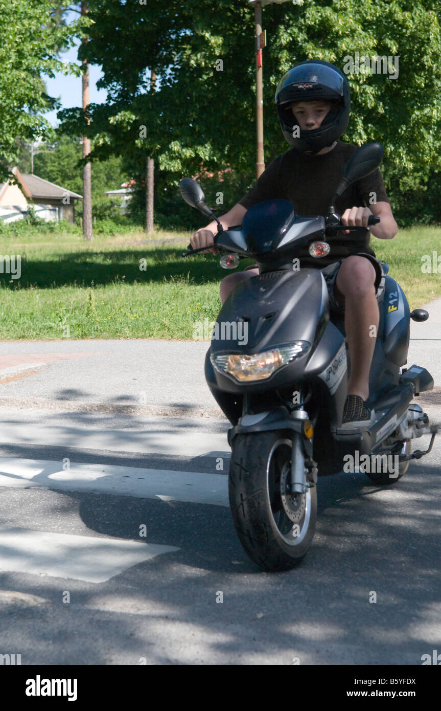 Boy driving a moped Stock Photo Alamy