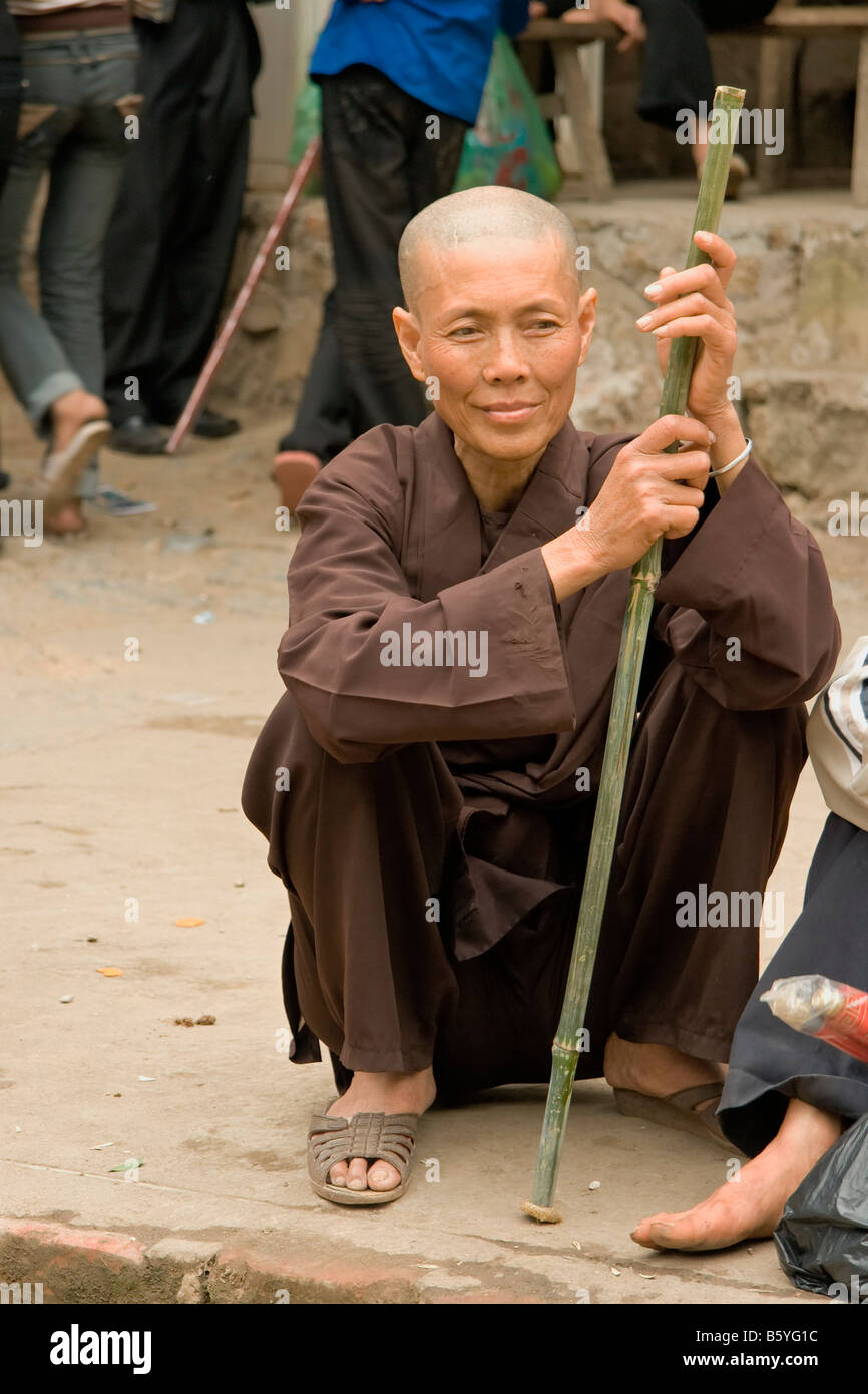 Vietnam  villager Buddhist sitting adult stick happy Stock Photo