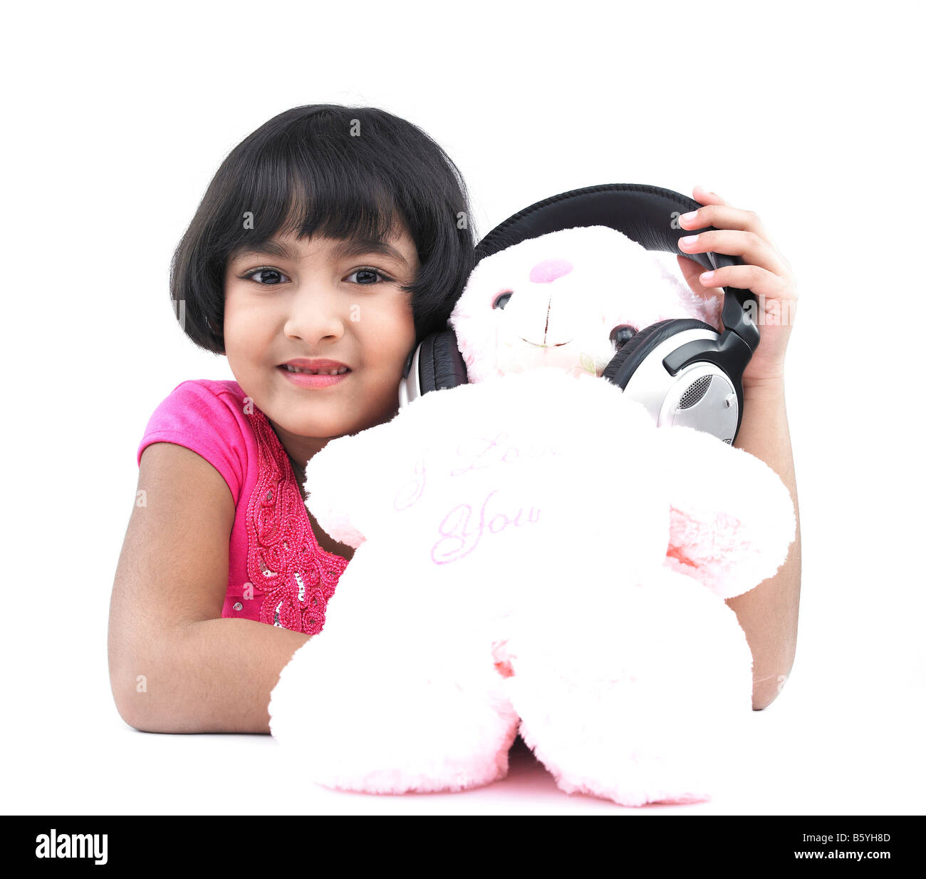 a pretty asian girl with her teddy bear wearing  the headphones Stock Photo