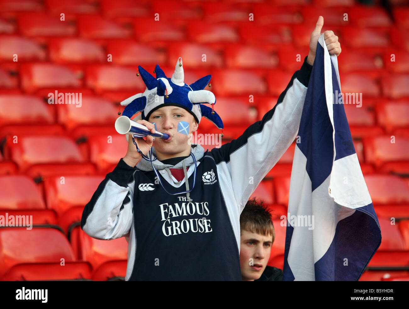 Young scotland fan with painted face cheering at a Scotland rugby match at Pittodrie Stadium, Aberdeen Stock Photo