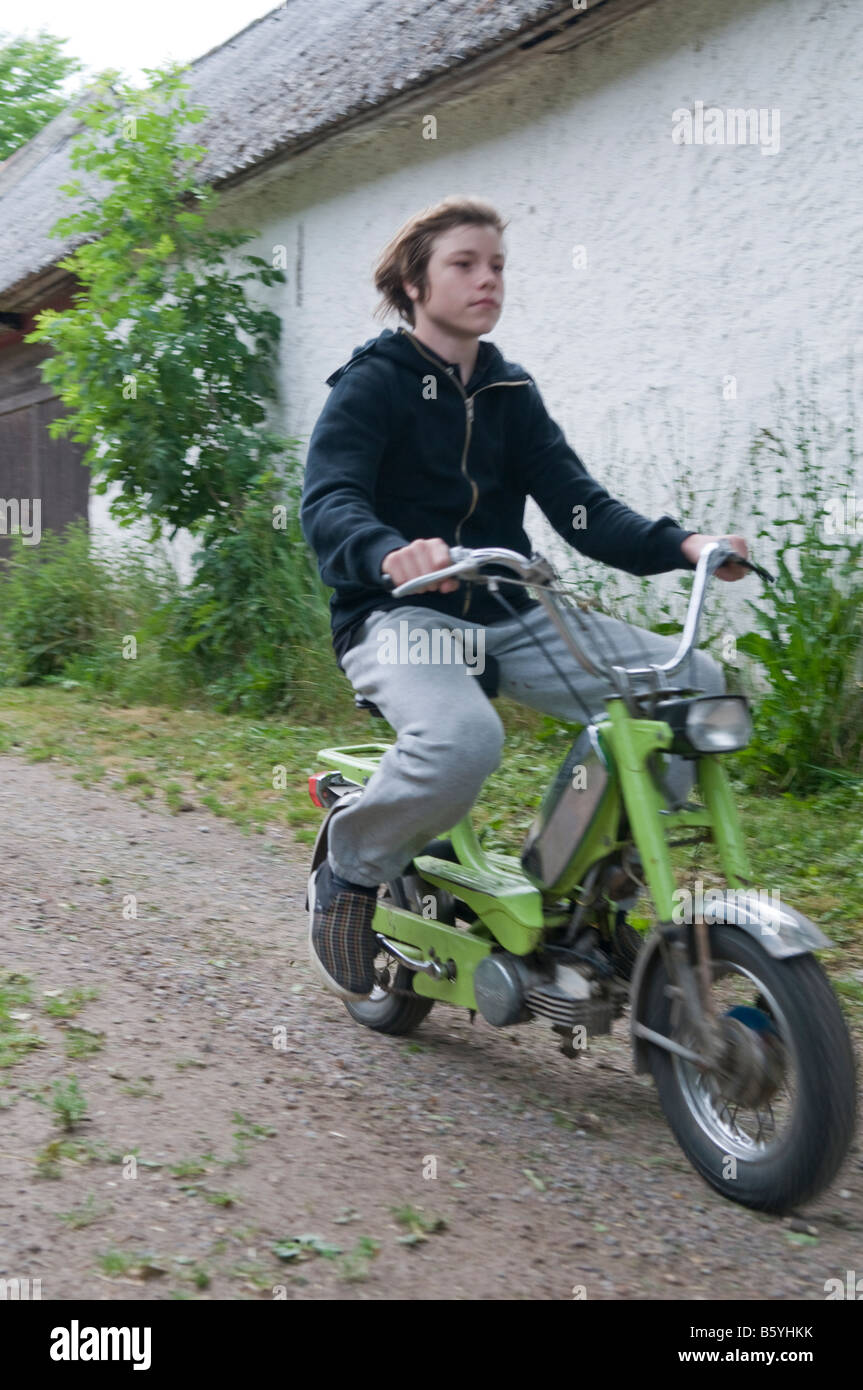Boy, not wearing a helmet, driving a moped Stock Photo Alamy