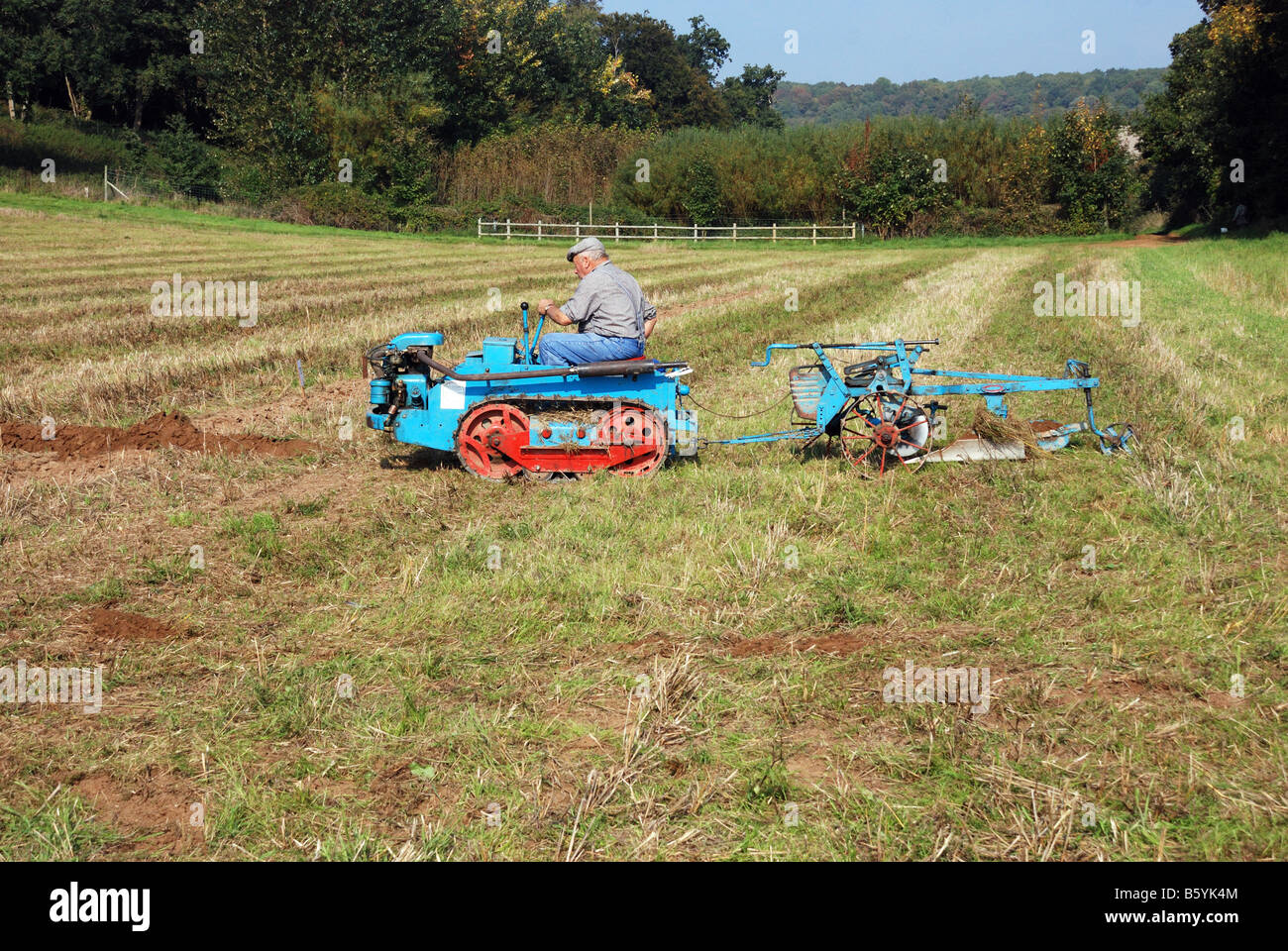 Vintage small sit on tracked tractor and plough by Ransomes of Ipswich at the Surrey County Ploughing Match Country Fair 2008 Stock Photo
