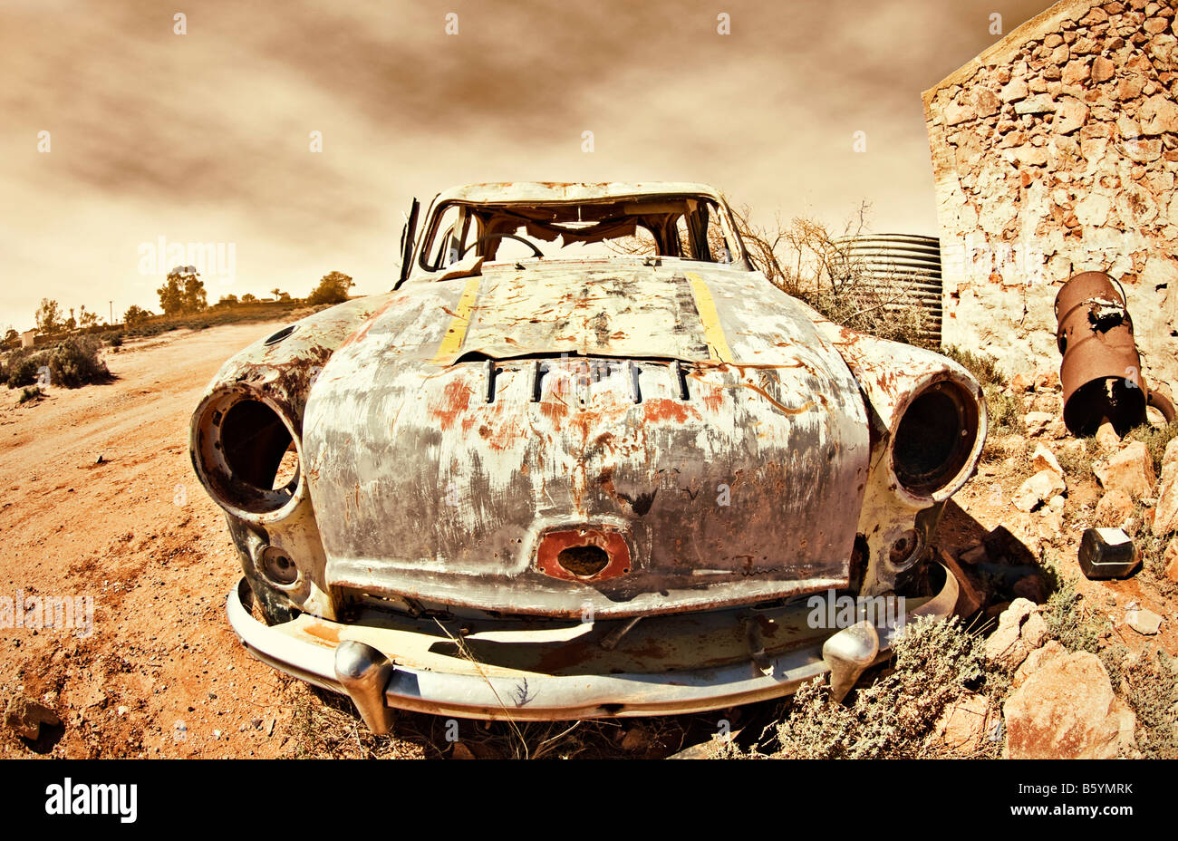 great image of an old car rusting away in the desert Stock Photo
