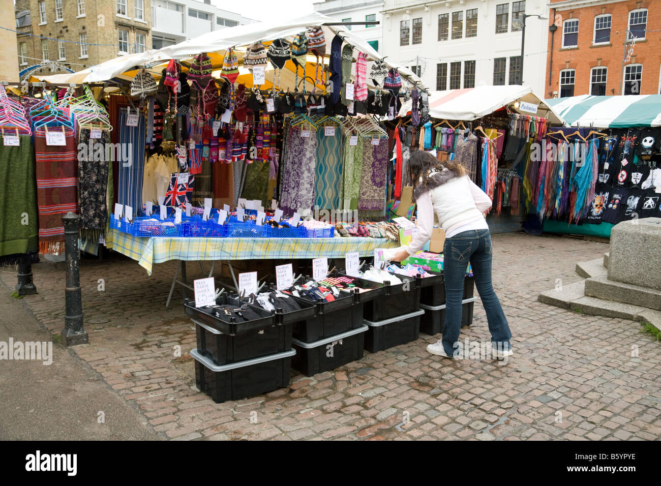 A teenage girl shops for clothes in Cambridge market, Cambridgeshire UK Stock Photo