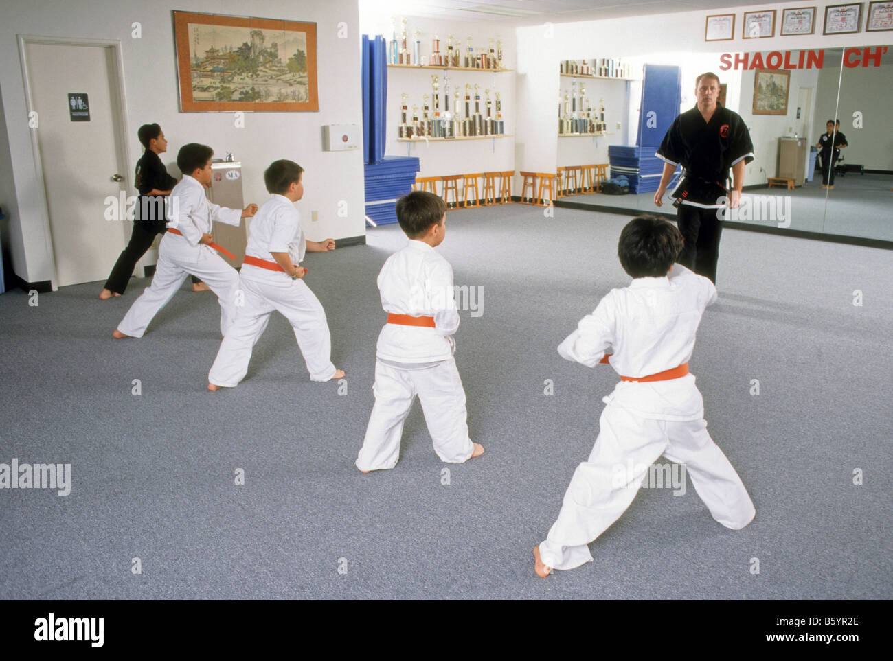 Sensei teaches boys during karate class. Stock Photo