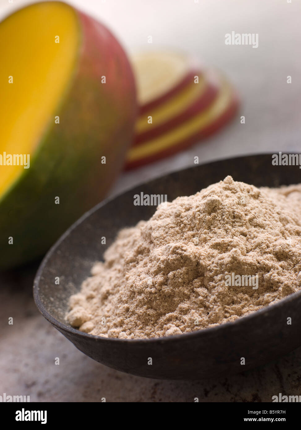 Dish of Mango Powder with sliced Fresh Mango Stock Photo