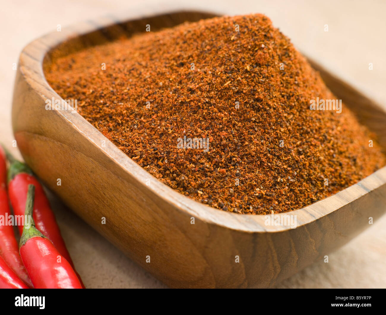 Dish of Hot Chili Powder with Fresh Chilies Stock Photo