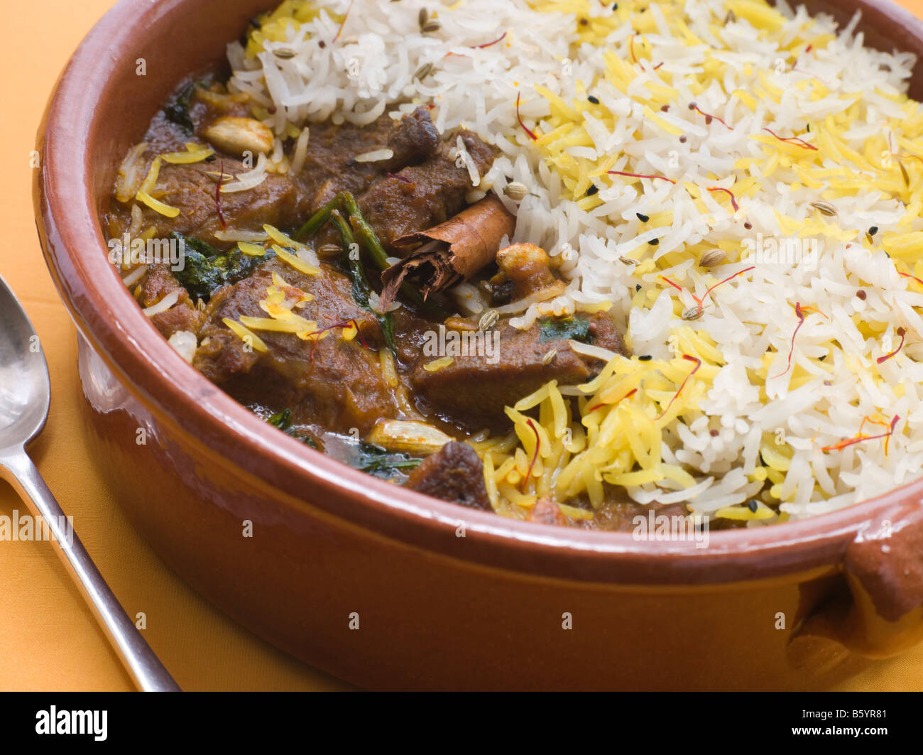 Pot of Lamb Biryani with a spoon Stock Photo