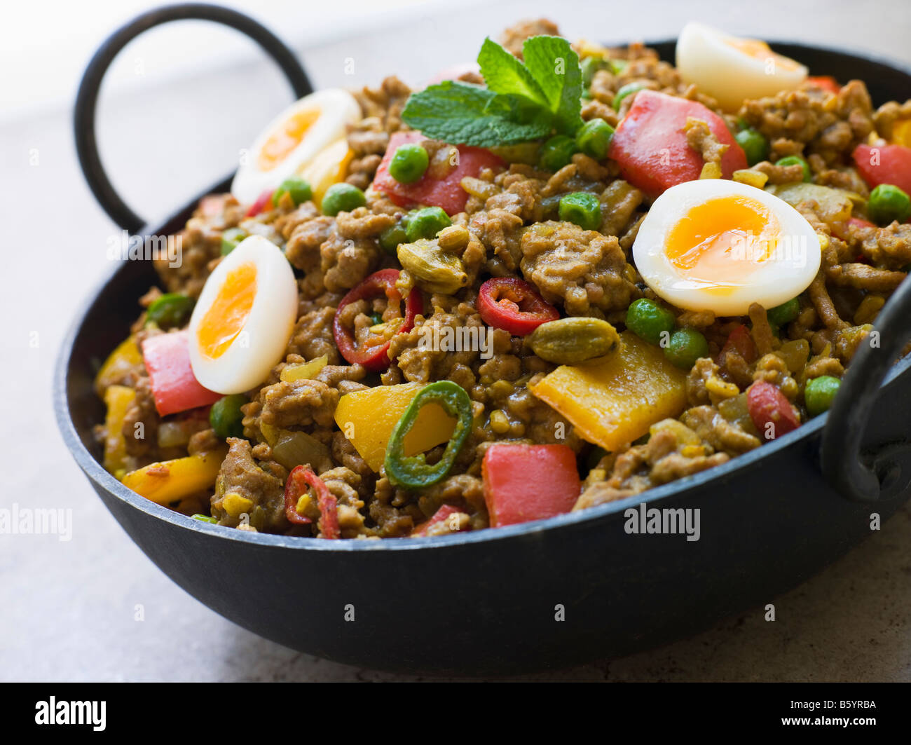 Karahi Dish with Punjabi Keema Mattar and Quail Eggs Stock Photo