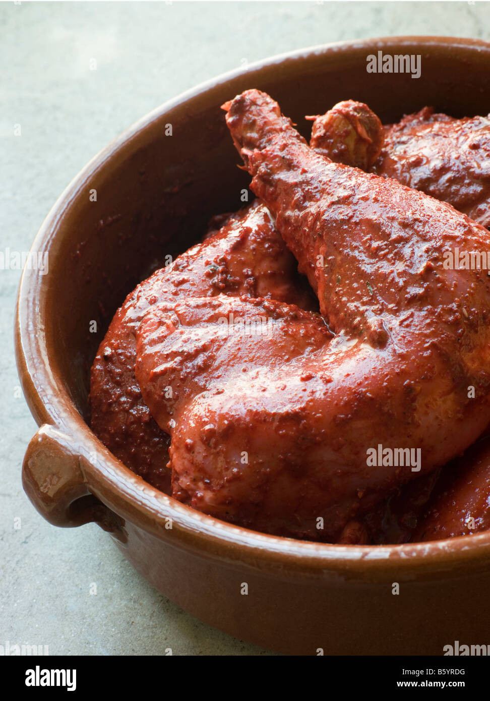 Chicken Legs Marinating in Tandoori Paste Stock Photo
