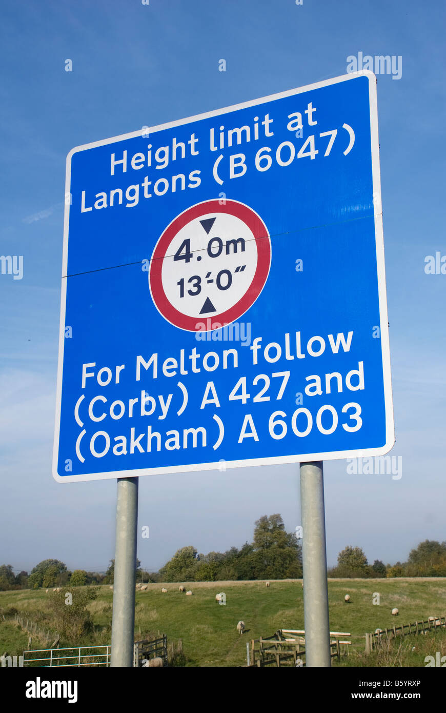 Blue road sign warning of height limit on road ahead in the uk Stock