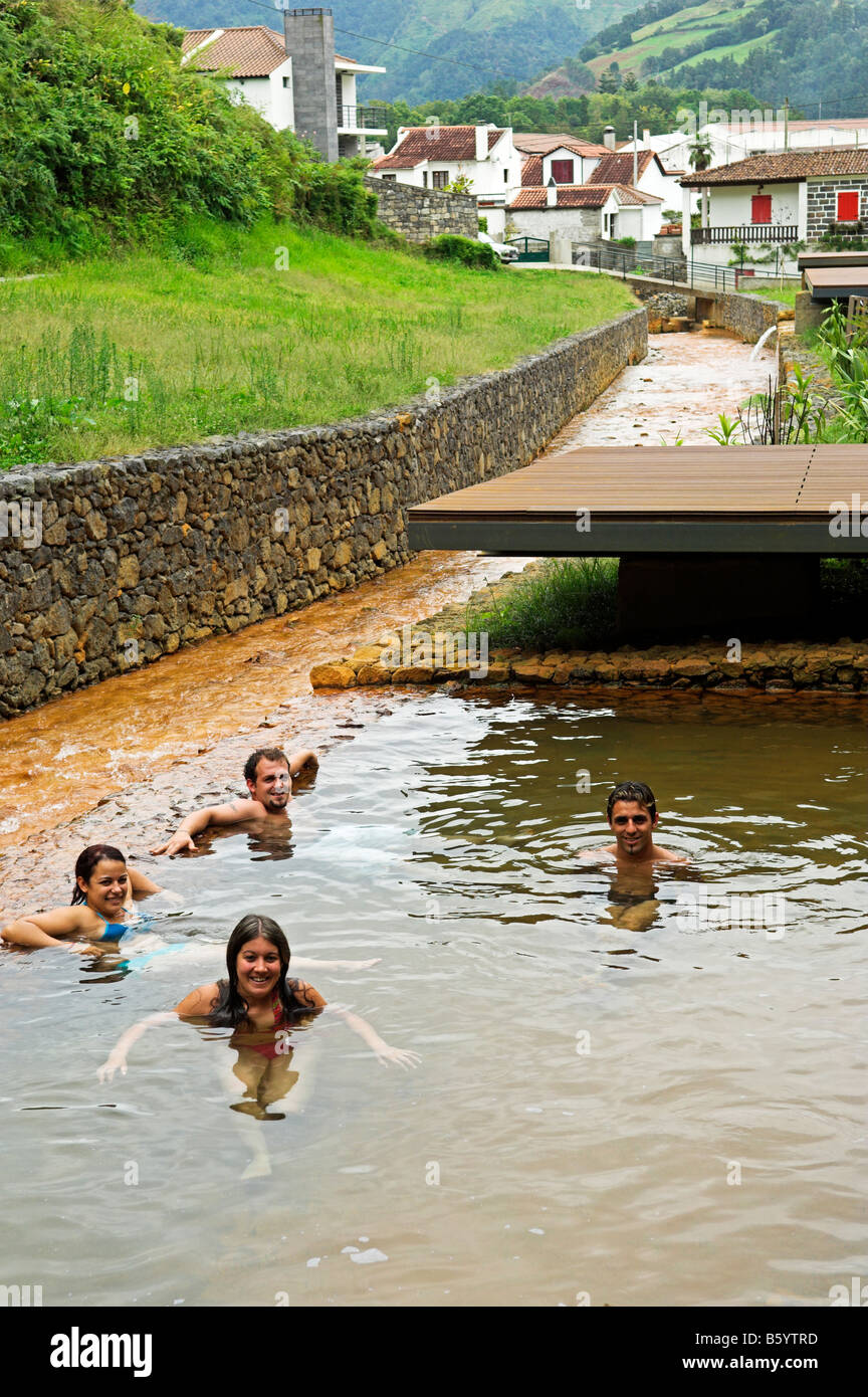 People relaxing in outdoor thermal mineral spring pool town of Furnas Sao Miguel Azores Islands Portugal Stock Photo